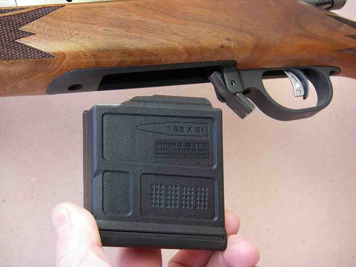 The rifle features a detachable magazine.